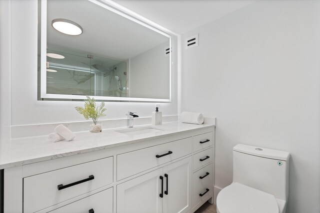 2800 E Sunrise Blvd Unit 4C, Fort Lauderdale, FL 33304 - bathroom with a marble finish shower, vanity, and toilet
