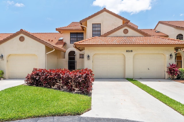 8316 Waterline Dr Unit 103, Boynton Beach, FL 33472 - mediterranean / spanish house with stucco siding, a garage, concrete driveway, and a tiled roof