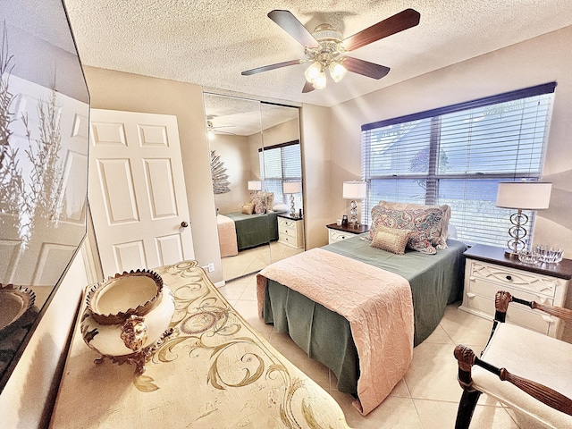 7780 Lake Champlain Ct, Delray Beach, FL 33446 - bedroom with light tile patterned floors, a textured ceiling, a closet, and ceiling fan
