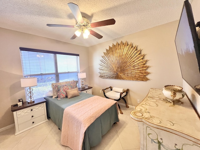 7780 Lake Champlain Ct, Delray Beach, FL 33446 - bedroom featuring light tile patterned flooring, a textured ceiling, a ceiling fan, and baseboards
