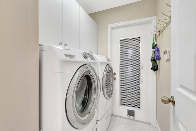 7780 Lake Champlain Ct, Delray Beach, FL 33446 - laundry area featuring washing machine and clothes dryer, cabinet space, light tile patterned flooring, and baseboards
