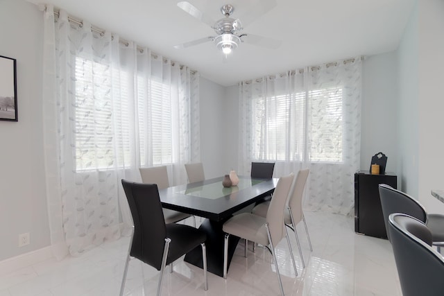 3185 Laurel Ridge Cir, Riviera Beach, FL 33404 - dining room with a ceiling fan, light marble finish flooring, and baseboards