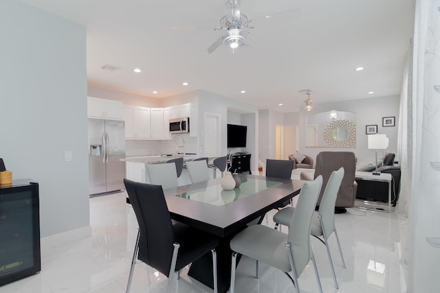 3185 Laurel Ridge Cir, Riviera Beach, FL 33404 - dining space featuring ceiling fan, recessed lighting, light marble finish floors, and baseboards