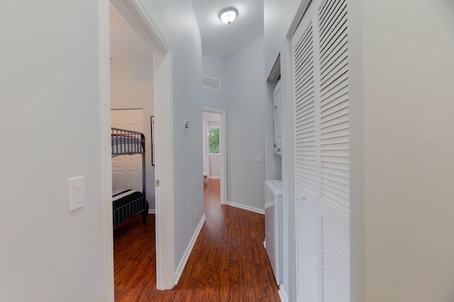 3185 Laurel Ridge Cir, Riviera Beach, FL 33404 - hallway with wood finished floors, stacked washer / dryer, and baseboards
