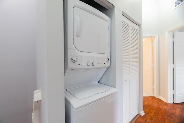 3185 Laurel Ridge Cir, Riviera Beach, FL 33404 - washroom with estacked washer and dryer and wood finished floors