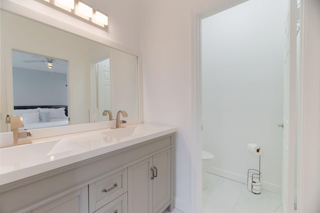 3185 Laurel Ridge Cir, Riviera Beach, FL 33404 - full bathroom featuring marble look tiles, double vanity, ensuite bathroom, toilet, and baseboards