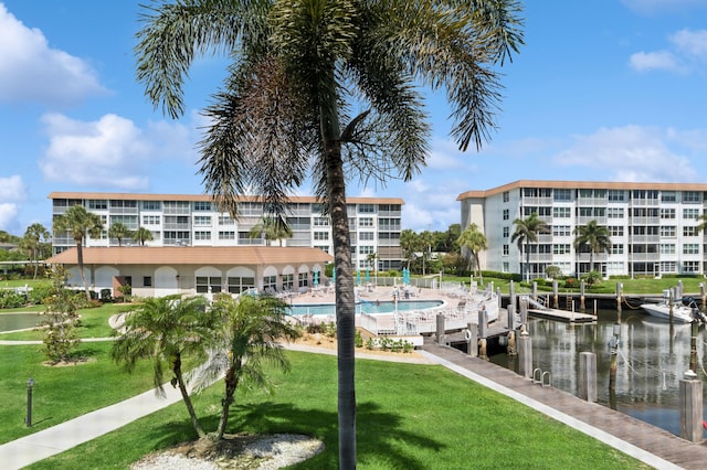 911 Gardenia Dr Unit 252, Delray Beach, FL 33483 - dock featuring a lawn, a community pool, and a water view