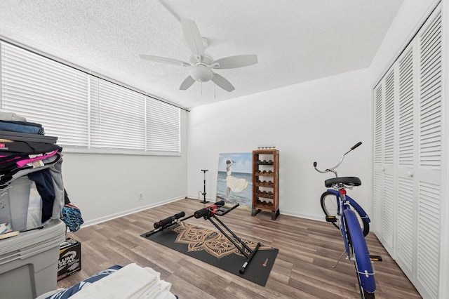 911 Gardenia Dr Unit 252, Delray Beach, FL 33483 - exercise area featuring ceiling fan, wood finished floors, baseboards, and a textured ceiling