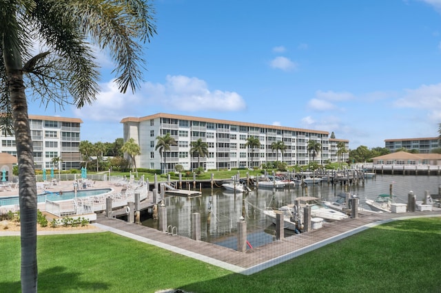 911 Gardenia Dr Unit 252, Delray Beach, FL 33483 - dock featuring a yard, a water view, and boat lift