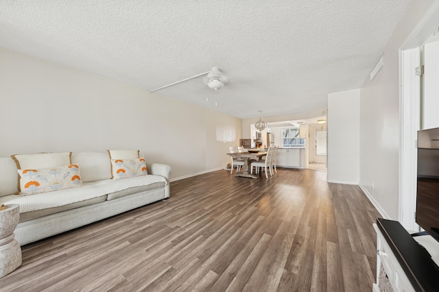 911 Gardenia Dr Unit 252, Delray Beach, FL 33483 - living area with wood finished floors, baseboards, a textured ceiling, and ceiling fan