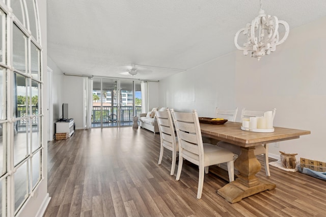 911 Gardenia Dr Unit 252, Delray Beach, FL 33483 - dining area with wood finished floors, a chandelier, a textured ceiling, and expansive windows