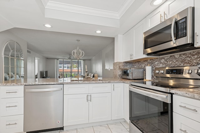 911 Gardenia Dr Unit 252, Delray Beach, FL 33483 - kitchen with stainless steel appliances, light marble finish floors, a sink, crown molding, and a chandelier