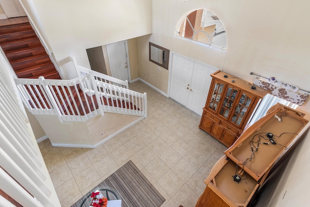 6815 Farragut Ln, Boynton Beach, FL 33437 - tiled foyer entrance featuring a high ceiling, baseboards, and stairway