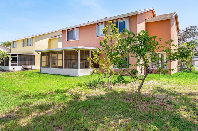 6815 Farragut Ln, Boynton Beach, FL 33437 - back of house featuring a sunroom, stucco siding, and a lawn