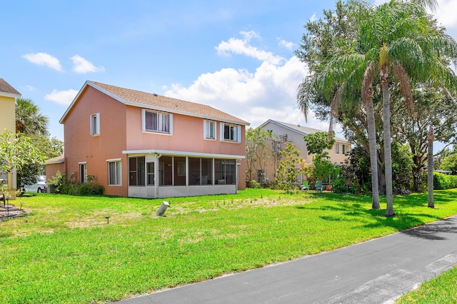 6815 Farragut Ln, Boynton Beach, FL 33437 - back of house featuring a sunroom, a yard, and stucco siding