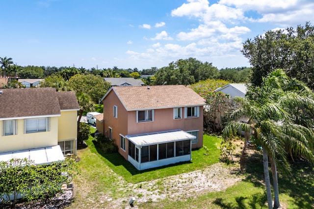 6815 Farragut Ln, Boynton Beach, FL 33437 - back of property featuring a sunroom, a lawn, and stucco siding