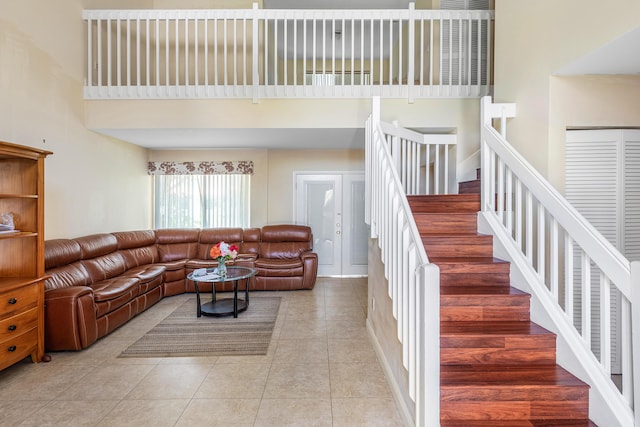 6815 Farragut Ln, Boynton Beach, FL 33437 - living area with a towering ceiling, light tile patterned flooring, and stairway