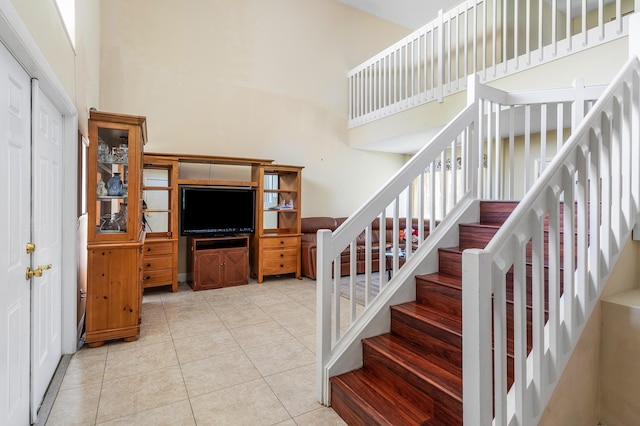 6815 Farragut Ln, Boynton Beach, FL 33437 - staircase featuring a high ceiling and tile patterned floors