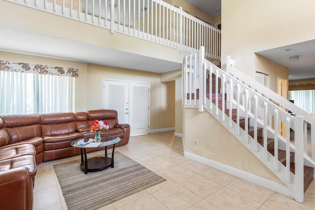 6815 Farragut Ln, Boynton Beach, FL 33437 - tiled living room with a towering ceiling, stairs, and baseboards