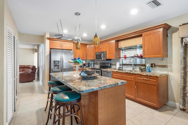 6815 Farragut Ln, Boynton Beach, FL 33437 - kitchen with appliances with stainless steel finishes, a sink, light tile patterned floors, brown cabinets, and recessed lighting