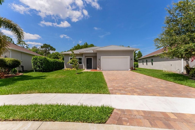 675 NE Moss Rose Pl, Port Saint Lucie, FL 34983 - single story home with decorative driveway, an attached garage, a front yard, and stucco siding