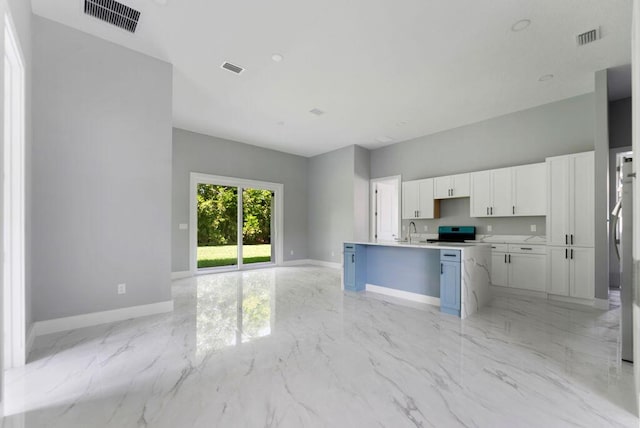 675 NE Moss Rose Pl, Port Saint Lucie, FL 34983 - kitchen featuring stainless steel electric range, baseboards, a sink, and light marble finish flooring