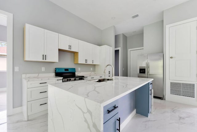 675 NE Moss Rose Pl, Port Saint Lucie, FL 34983 - kitchen featuring stainless steel appliances, light marble finish flooring, a sink, and light stone countertops