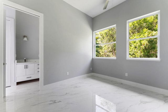 675 NE Moss Rose Pl, Port Saint Lucie, FL 34983 - spare room with marble finish flooring, baseboards, and a sink