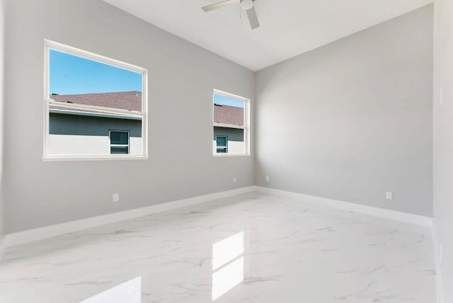 675 NE Moss Rose Pl, Port Saint Lucie, FL 34983 - empty room with marble finish floors, baseboards, and ceiling fan