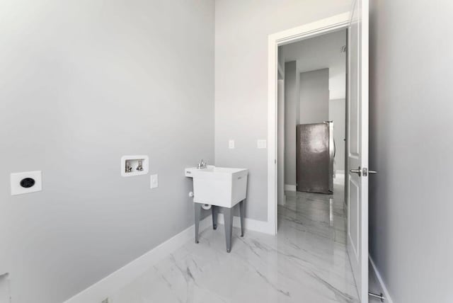 675 NE Moss Rose Pl, Port Saint Lucie, FL 34983 - laundry area featuring electric dryer hookup, washer hookup, light marble finish flooring, and baseboards