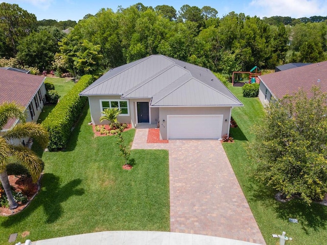 675 NE Moss Rose Pl, Port Saint Lucie, FL 34983 - ranch-style home featuring a garage, stucco siding, decorative driveway, a front yard, and metal roof