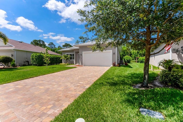 675 NE Moss Rose Pl, Port Saint Lucie, FL 34983 - view of front facade featuring a front yard, stucco siding, a garage, driveway, and a standing seam roof