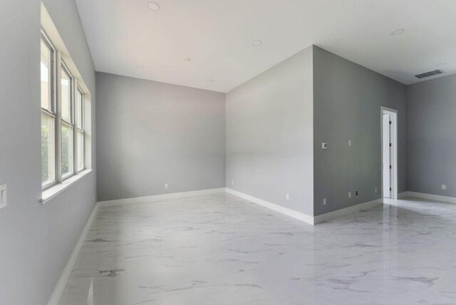 675 NE Moss Rose Pl, Port Saint Lucie, FL 34983 - spare room with light marble finish flooring and baseboards