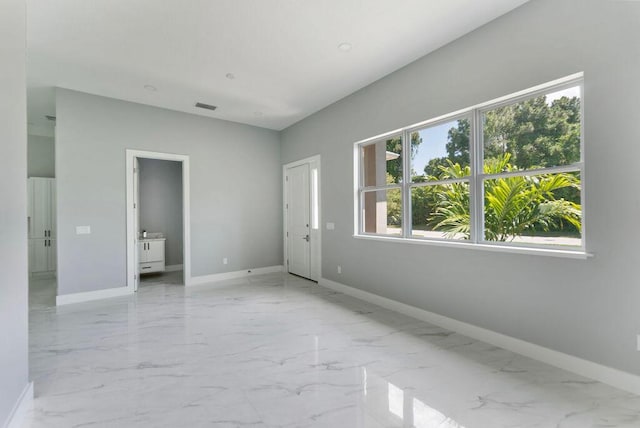 675 NE Moss Rose Pl, Port Saint Lucie, FL 34983 - unfurnished bedroom with baseboards and marble finish flooring