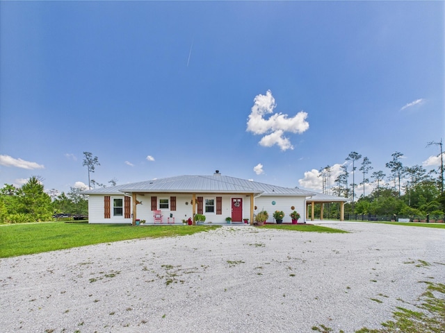 32801 US Highway 441 13 & 14, Okeechobee, FL 34972 - view of front facade with a porch, gravel driveway, a front yard, and metal roof