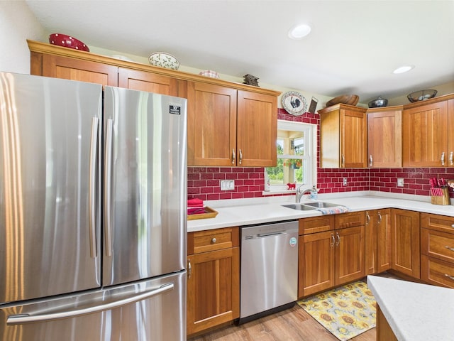 32801 US Highway 441 13 & 14, Okeechobee, FL 34972 - kitchen with stainless steel appliances, a sink, light countertops, tasteful backsplash, and light wood-style flooring