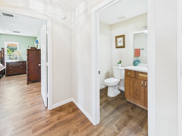 32801 US Highway 441 13 & 14, Okeechobee, FL 34972 - bathroom with vanity, wood finished floors, toilet, and baseboards