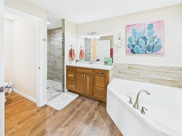 32801 US Highway 441 13 & 14, Okeechobee, FL 34972 - full bathroom with vanity, a shower stall, a bath, wood finished floors, and baseboards