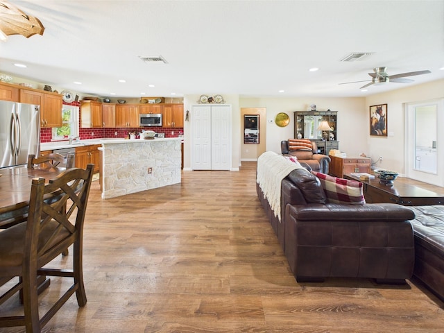 32801 US Highway 441 13 & 14, Okeechobee, FL 34972 - living area with light wood-type flooring, ceiling fan, and recessed lighting