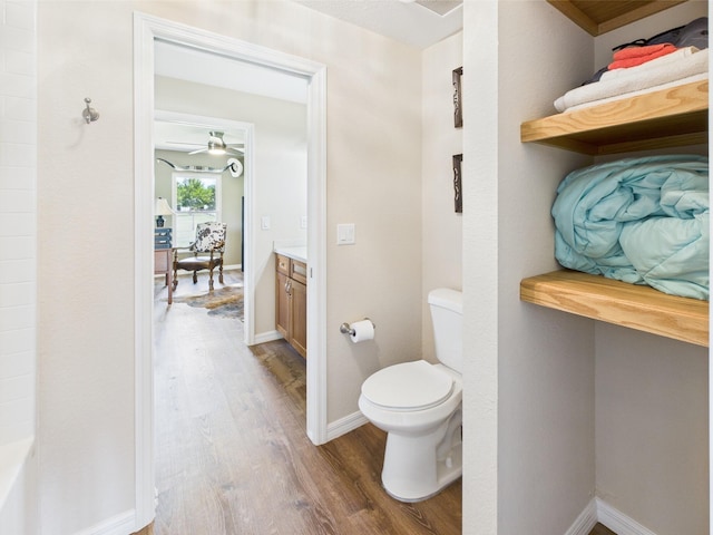 32801 US Highway 441 13 & 14, Okeechobee, FL 34972 - bathroom with wood finished floors, toilet, vanity, ceiling fan, and baseboards