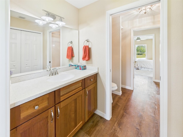 32801 US Highway 441 13 & 14, Okeechobee, FL 34972 - ensuite bathroom with wood finished floors, toilet, vanity, a closet, and baseboards