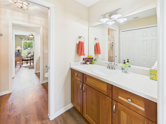 32801 US Highway 441 13 & 14, Okeechobee, FL 34972 - bathroom featuring vanity, wood finished floors, baseboards, and toilet
