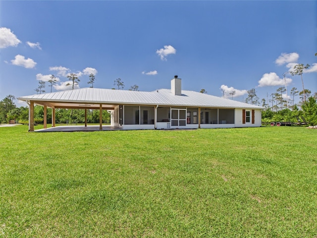 32801 US Highway 441 13 & 14, Okeechobee, FL 34972 - rear view of property featuring a sunroom, a chimney, a yard, and an attached carport
