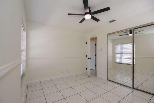 11405 Whisper Lake Way, Boca Raton, FL 33428 - unfurnished bedroom featuring a closet, light tile patterned floors, and ceiling fan