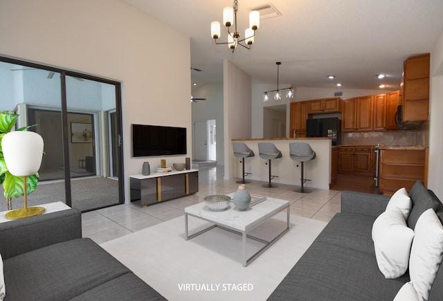 11405 Whisper Lake Way, Boca Raton, FL 33428 - living room with a chandelier, lofted ceiling, and light tile patterned floors
