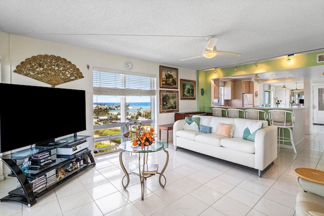 2611 N Riverside Dr Unit 908, Pompano Beach, FL 33062 - living room with a ceiling fan, a textured ceiling, and light tile patterned flooring