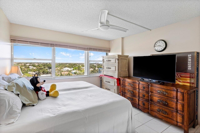 2611 N Riverside Dr Unit 908, Pompano Beach, FL 33062 - bedroom featuring a textured ceiling and a ceiling fan