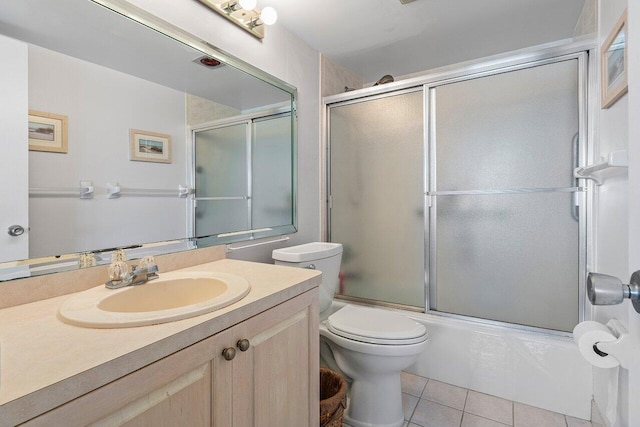2611 N Riverside Dr Unit 908, Pompano Beach, FL 33062 - full bathroom featuring tile patterned floors, toilet, bath / shower combo with glass door, and vanity
