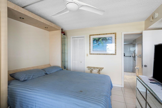 2611 N Riverside Dr Unit 908, Pompano Beach, FL 33062 - bedroom featuring light tile patterned floors, a closet, a textured ceiling, ceiling fan, and ensuite bathroom