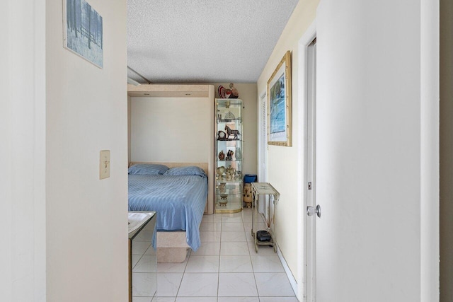 2611 N Riverside Dr Unit 908, Pompano Beach, FL 33062 - bedroom with a textured ceiling and light tile patterned floors